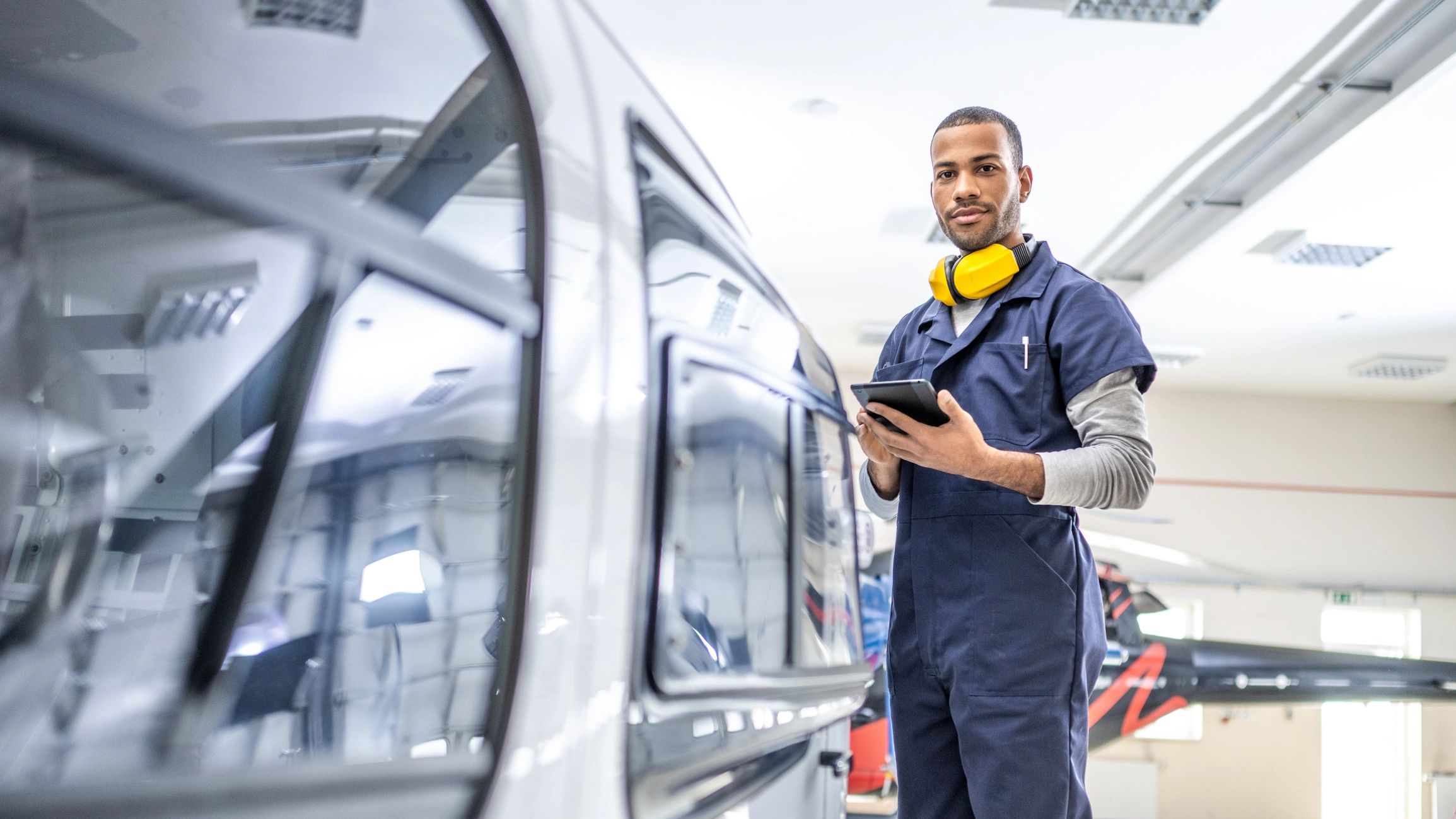 Diesel mechanic working with tools on heavy equipment