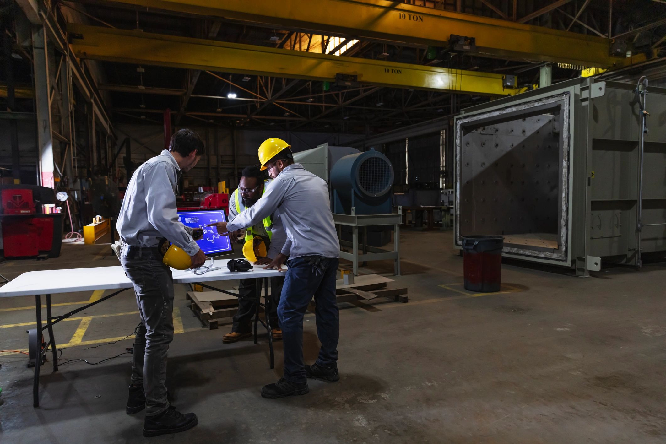 Heavy-duty truck repair shop service bay with technicians